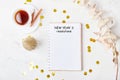 New Years resolutions text on white mock up notebook on the festive desk with coffee cup Royalty Free Stock Photo