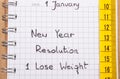 New years resolutions written in notebook and tape measure Royalty Free Stock Photo