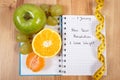 New years resolutions written in notebook and tape measure Royalty Free Stock Photo