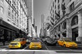 NEW YORK - APRIL 15: Yellow taxis rides on 5th Avenue on April 1