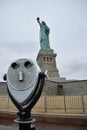 New York binocular next to Lady Liberty