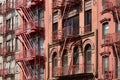 New York bricks buildings facades with fire escape stairs Royalty Free Stock Photo