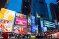 New York, Broadway at night. Colorful large billboards and crowd waiting for the shows