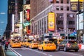 New York, Broadway streets at night. Colorful neon lights, ads and people walking