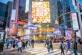 New York, Broadway streets at night. Illuminated high buildings, colorful neon lights, ads and people walking Royalty Free Stock Photo