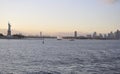 New York City,August 2nd:New Jersey City skyline and Statue of Liberty at sunset over Hudson river Royalty Free Stock Photo