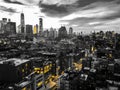 New York City black and white nighttime cityscape with glowing yellow lights in the skyline buildings of downtown Manhattan Royalty Free Stock Photo
