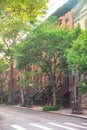 New York City with brownstones apartments homes and trees.