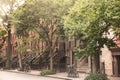 New York City with brownstones apartments homes and trees.