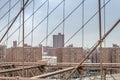 New York City Buildings and Skyscrapers  Covered in Fog. View Through Brooklyn Bridge Cables Royalty Free Stock Photo