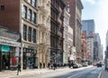 New York City, 2018: People walk down the sidewalk in SoHo