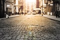 New York City - Cobblestone Street View In Soho With Sunlight Background In Black And White
