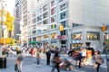 Crowds of people walk across the crosswalk at the busy intersection at Union Square Park and 14th Street at rush hour in New York