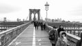 NEW YORK CITY - DECEMBER 2018: Cars traffic and people walking over Brooklyn Bridge from Manhattan and Brooklyn. Slow motion Royalty Free Stock Photo