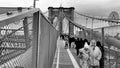 NEW YORK CITY - DECEMBER 2018: Cars traffic and people walking over Brooklyn Bridge from Manhattan and Brooklyn. Slow motion Royalty Free Stock Photo
