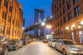 NEW YORK CITY - DECEMBER 6, 2018: Night view of the Empire State Building through the pylons of Manhattan Bridge. View from Royalty Free Stock Photo