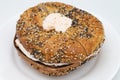 New York City Everything Bagel Filled with Lox Spread Cream Cheese on a White Plate Royalty Free Stock Photo