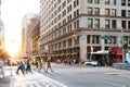 Intersection of 23rd Street and 5th Avenue is busy with people and traffic with colorful sunset in New York City