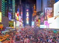 NEW YORK CITY - JUNE 8, 2013: Panoramic night aerial view of Times Square ads and tourists from Duffy Square red steps Royalty Free Stock Photo