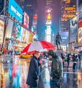 NEW YORK CITY - JUNE 13, 2013: Tourists enjoy night life in Times Square. New York attracts 50 million people from all over the Royalty Free Stock Photo