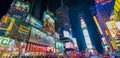 NEW YORK CITY - JUNE 13, 2013: Tourists enjoy night life in Times Square. New York attracts 50 million people from all over the Royalty Free Stock Photo