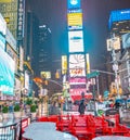 NEW YORK CITY - JUNE 13, 2013: Tourists enjoy night life in Times Square. New York attracts 50 million people from all over the Royalty Free Stock Photo