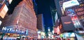 NEW YORK CITY - JUNE 13, 2013: Tourists enjoy night life in Times Square. New York attracts 50 million people from all over the Royalty Free Stock Photo