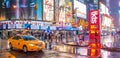 NEW YORK CITY - JUNE 13, 2013: Tourists enjoy night life in Times Square. New York attracts 50 million people from all over the Royalty Free Stock Photo