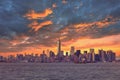 New York City Manhattan downtown skyline at dusk with skyscrapers illuminated over Hudson River panorama. Dramatic Royalty Free Stock Photo