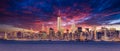 New York City Manhattan downtown skyline at dusk with skyscrapers illuminated over Hudson River panorama. Dramatic Royalty Free Stock Photo