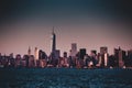 New York City Manhattan downtown skyline at dusk with skyscrapers illuminated over Hudson River panorama. Royalty Free Stock Photo