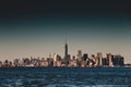 New York City Manhattan downtown skyline at dusk with skyscrapers illuminated over Hudson River panorama. Royalty Free Stock Photo