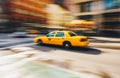New York City - March 20, 2017 : Yellow taxi cab speeds down in a New York City Street. Shot with long shutter speed for