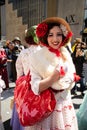 Woman in red polka dot themed costume at Easter Bonnet Parade