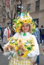 Woman in sunflower costume holding her dogs in Easter Bonnet Parade