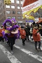 New York City, NY, February 12, 2023: A parade participant marches down Mott Street, in a purple dragon costume as part of the ann