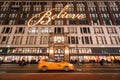 Macy`s Department Store with Christmas window display decorations and passing New York Taxi. Midtown Manhattan. New York City Royalty Free Stock Photo