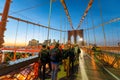 NEW YORK CITY - OCTOBER 2015: Tourists and locals walk along the Brooklyn Bridge at sunset, USA Royalty Free Stock Photo