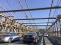 NEW YORK CITY - OCTOBER 2015: Traffic on the Brooklyn Bridge with cars speeding up on a sunny day Royalty Free Stock Photo