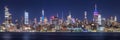 New York City panoramic cityscape of Manhattan Midtown West skyscrapers at night along Hudson River. NYC, USA