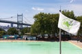 New York City Parks and Recreation Flag and the Empty Astoria Pool during Summer with the Triborough Bridge in the Background