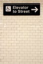 New York City Station subway directional sign on tile wall. Royalty Free Stock Photo