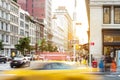 New York City street scene with yellow taxi cab driving down 5th Avenue through Midtown Manhattan Royalty Free Stock Photo