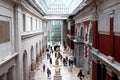 New York City, United States. People in a large hall on the ground floor in the Metropolitan Museum in New Y