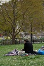 New York City empty streets, homeless man sitting in the park Royalty Free Stock Photo