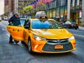New York City, USA - April 2018: Man getting on yellow taxi in Manhattan