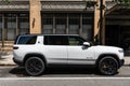 New York City, USA - August 06, 2023: Rivian R1S SUV white electric car passenger side view, parked