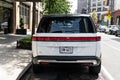 New York City, USA - August 06, 2023: Rivian R1S SUV white electric car rear view, parked