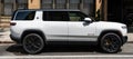 New York City, USA - August 06, 2023: Rivian R1S SUV white electric car view from the passenger side, parked