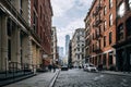 Early morning traffic and tourist walking on the Mercer Street in SOHO New York City